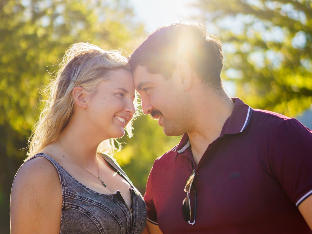Sarah and Charlie forehead to forehead in golden light